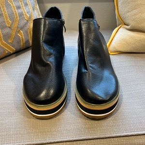 Black faux leather boots.